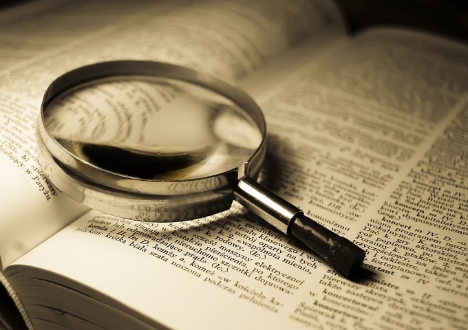 magnifying glass over a dictionary